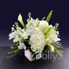 White floral arrangement in a square vase with lilies and hydrangeas