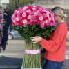 Large bouquet of pink and red roses with a crown topper