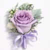 A single large lavender rose takes center stage in this wedding boutonniere
