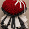 Heart-shaped red rose arrangement with black and white ribbon trim