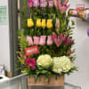 12 roses set in 3 rows with a combination of lilies and