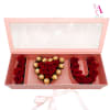 Pink gift box with red roses and Ferrero Rocher chocolates arranged in letters