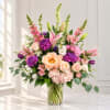 Pink and purple mixed bouquet in a clear glass vase