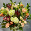 Bouquet of pale roses, hydrangeas, and peach flowers with a ribbon bow