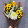 Bouquet of yellow and white flowers wrapped in brown paper