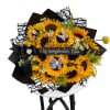 Sunflower bouquet with black wrapping and a birthday ribbon