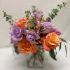 Bouquet of lavender and orange roses in a clear vase