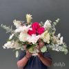 Large bouquet of pink roses, white lilies, and white blooms in a vase