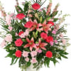 Pink roses and lilies in a tall mixed bouquet