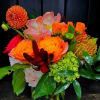 Bright mixed bouquet with orange and pink flowers in a vase