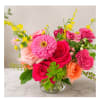 Pink and peach mixed flower bouquet in a clear glass vase