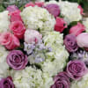 Bouquet of pink and lavender roses with white hydrangeas