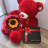 Red teddy bear with a sunflower bouquet and a black gift box with ribbon