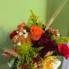 Mixed flower bouquet with a fox figurine and wheat stems