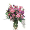 Pink and purple mixed bouquet in a clear glass vase