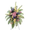 Standing floral spray with pink, yellow, and purple flowers