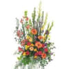 Tall mixed flower arrangement in a white container