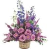 Basket arrangement of pink roses and purple flowers