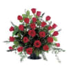 Red roses arranged in a black vase with greenery