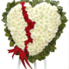 Heart-shaped white and red floral tribute on a stand