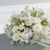 White floral arrangement with daisy-like blooms and baby's breath