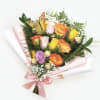Bouquet of multicolored roses with a pink ribbon and gold butterfly decoration