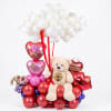 Balloon arrangement with a teddy bear and heart-shaped balloons