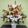 Mixed bouquet in a white vase with pink roses and white lilies