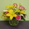 This is a simple arrangement that includes bright yellow Lilies, pink Roses