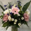 Mixed bouquet in a clear glass vase with pink gerberas and white calla lilies