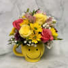 Mixed bouquet in a yellow smiley-face mug