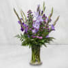 Purple flowers arranged in a clear glass vase