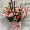 Pink rose bouquet in a gift bag with ribbon