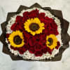 A dense cluster of deep red roses takes center stage in this