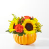 Ceramic pumpkin filled with sunflowers, roses, berries, etc. in traditional fall colors.