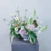 Pastel floral arrangement with pink roses and white daisies in a white vase