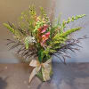 Tall mixed bouquet in a glass vase with a gold ribbon