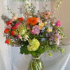 A loose, garden-style mixed bouquet that feels freshly gathered from a sunlit