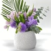 Lavender tulips and purple hyacinths in a white textured vase