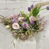 Lavender and pink bouquet in a beige vase