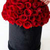 Red roses arranged in a black cylindrical box