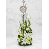 White floral sympathy arrangement with a heart memorial ornament