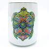 White candle jar with a colorful turtle design