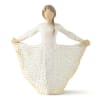 Figurine of a girl in a white dress with gold dots