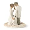 Figurine of a seated couple holding hands on a floral base