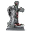 Stone angel statue beside a cross with pink flowers