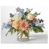 Mixed bouquet of roses, a pink chrysanthemum, and blue flowers in a glass vase