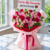 Bouquet of pink and red roses with a greeting card