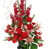 Red roses and lilies arranged in a black vase