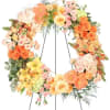 Large pastel floral wreath on a metal stand